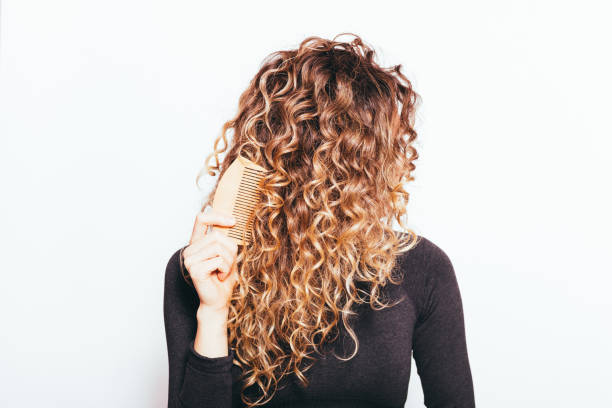 istock Young woman with long curly hair 1391820134