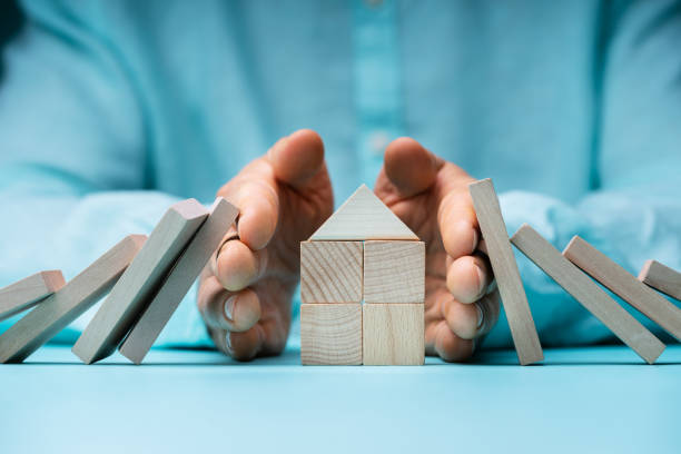 istock Hand Stopping Domino To Protect Home 1391821337