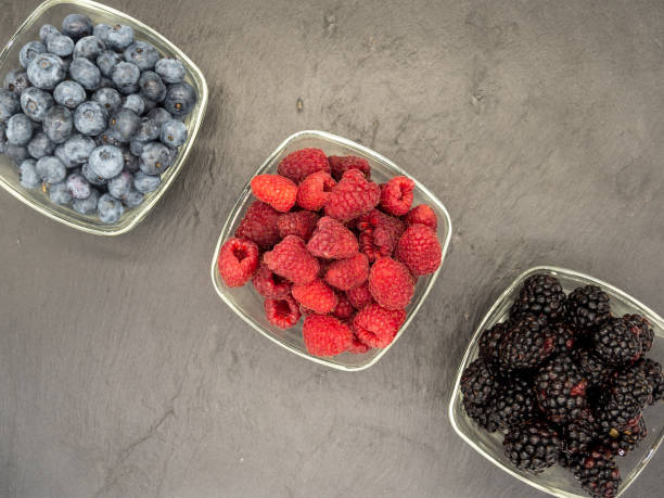 istock bowls with forest berries on black slate 1391821425