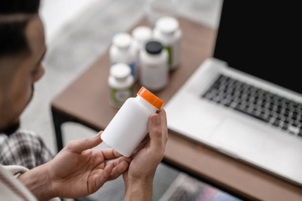 istock A man feeling unwell and taking pills 1391823510