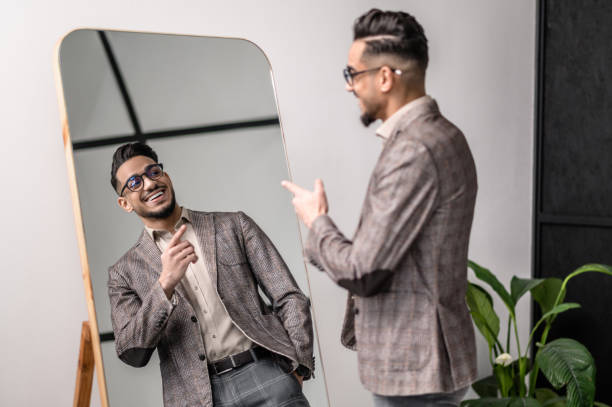 istock A good-looking young stylish man at the mirror 1391823587