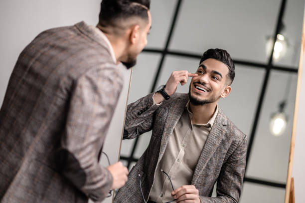 istock A good-looking young elegant man at the mirror 1391823590