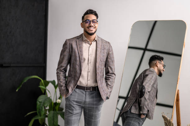 istock A good-looking young elegant man at the mirror 1391823594