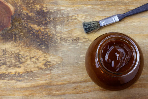 istock Barbecue sauce in bowl and brush on rustic wooden table 1391824328