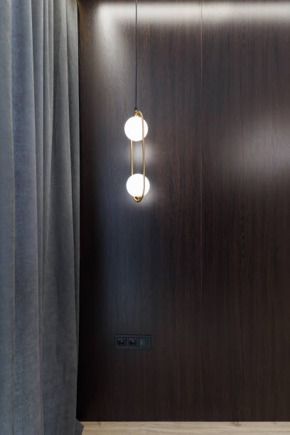 istock Stylish light bulb on the ceiling in a room with a designer interior. 1391825706
