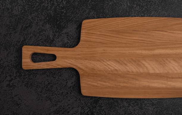 istock Wooden cutting board on a dark background. 1391826645