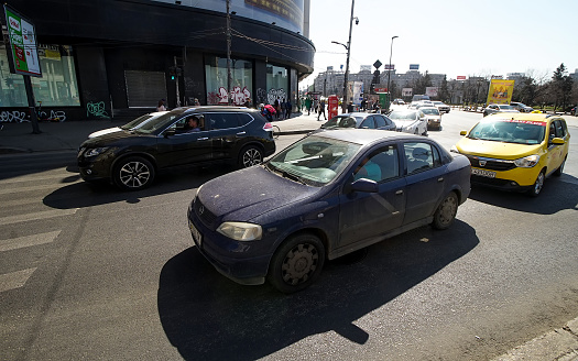 Bucharest, Romania - March 24, 2022: Cars in traffic at rush hour on a boulevard near \