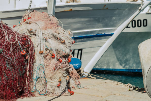 Fishing nets piled high at a commercial dock stock photo