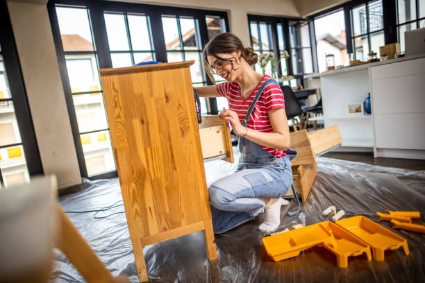 istock Woman is assembling furniture at home 1391829438