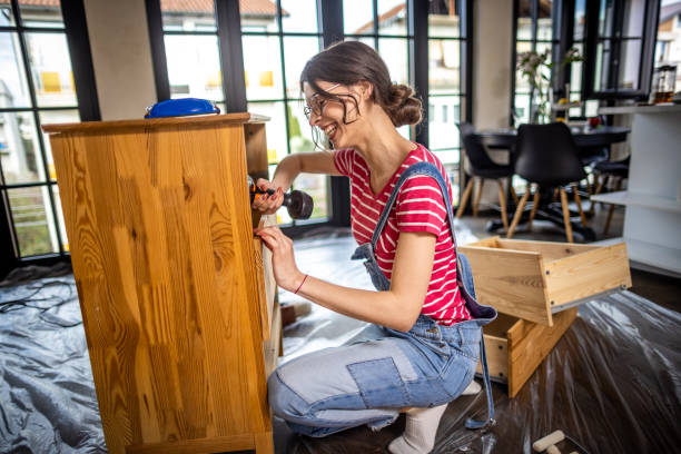 istock Woman is assembling furniture at home 1391829449