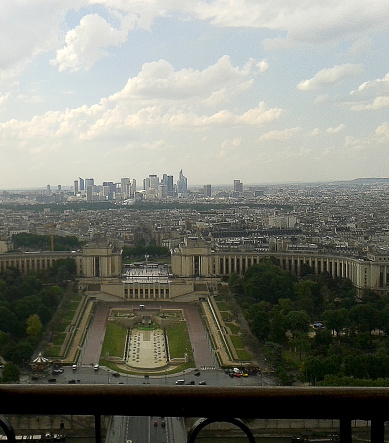The Palais de Chaillot, the Trocadẻro and La Dẻfense as seen from Eiffel Tower. People on boats, cars and bridge.The Eiffel tower is the most visited monument of France. Many tourist enjoy a sunny spring day around Eiffel Tower and Fountains in Paris, France