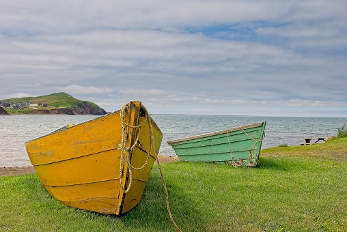 Shore of the St. Lawrence River in Iles-de-la-Madeleine, two rowboats waiting for fishermen