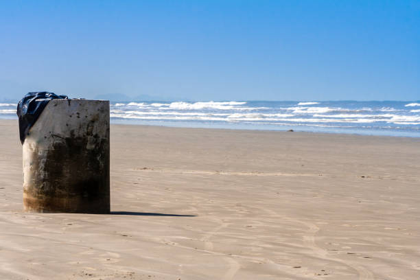 istock Cement trash can on the sand beach 1391835903