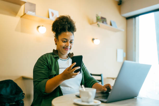 istock Woman using portable information device in coffee shop 1391837039