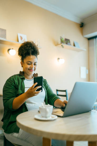 istock Woman using portable information device in coffee shop 1391837042