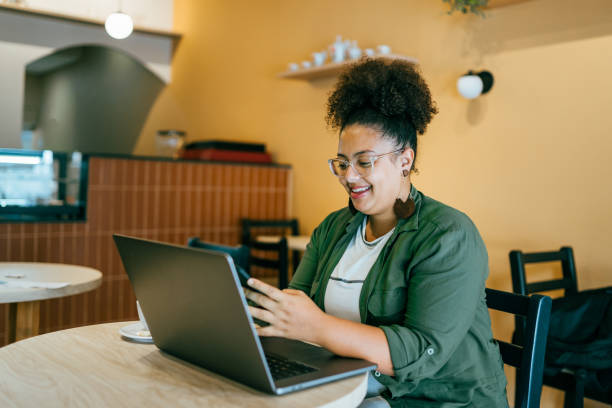 Woman using portable information device in coffee shop