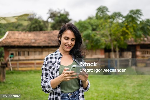 istock Female farmer using smartphone 1391837082