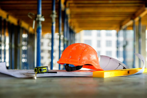 istock Blueprints project building, construction level and helmet, close up. Construction concept 1391837878