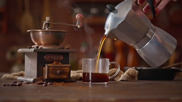 Woman pouring coffee from a geyser coffee maker