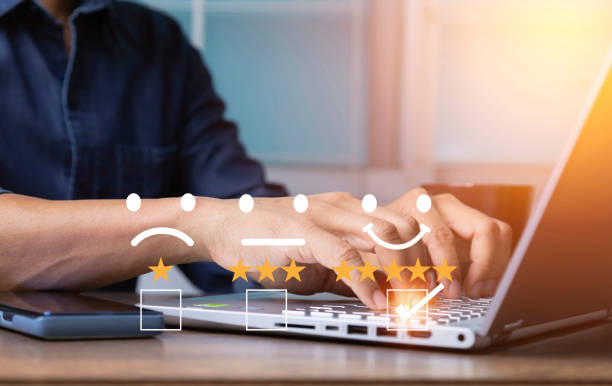 istock Satisfaction customer service survey concept, business man hand analyzing questionnaire and combining the satisfaction score with computer laptop, giving satisfaction rating with smile icon five stars 1391843263