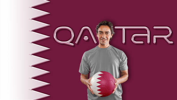Qatar flag with player holding soccer ball