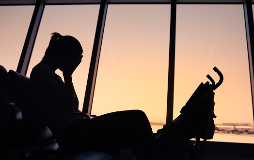 Stressed woman sitting in the airport.