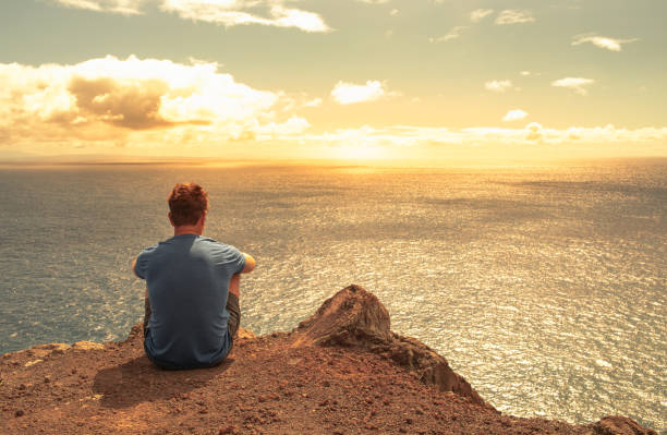istock Man hiker enjoying beautiful sunset view from the mountain top. 1391844441