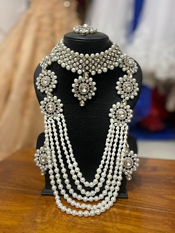 Young woman with elegant jewelry on dark grey background, closeup