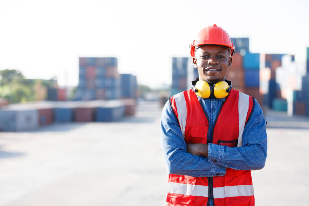 istock portrait African factory worker or engineer folded arms pose in containers warehouse storage 1391851290
