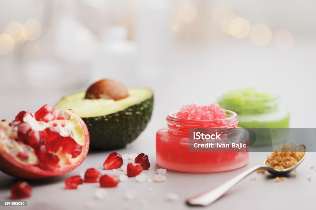 Fruit Body Scrubs Fruit body skin scrubs with pomegranate, avocado and brown sugar. Make-Up Stock Photo