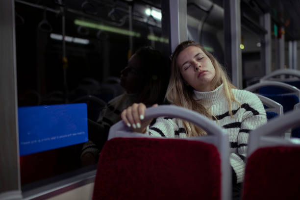 istock A female worker uses public transportation to return home. 1391854348