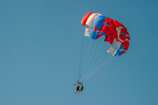 Antalya, Turkey - September 3, 2019 : A family who came to Antalya for a holiday got on a parachute attached to a two-person speedboat.