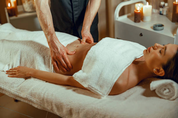 istock Relaxed female client getting stomach massage in spa salon 1391859774