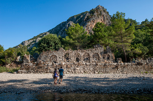 Antalya, Turkey - September 5, 2015 : A couple of tourists visiting the old port of the ancient city of Olympos at the foot of Mount Musa