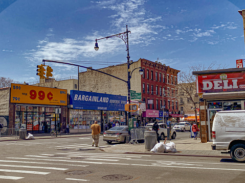 A 99 cent store and the Bargainland Department Store sit opposite a deli at the intersection of Fulton Street and Throop in Bed-Stuy Brooklyn.