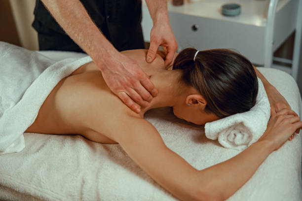 istock Professional masseur man doing back massage for female client at spa center. Relaxation, therapy 1391865761