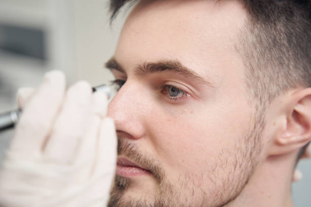 istock Neurologist checking man eye reactions in clinic 1391878426