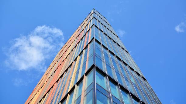 istock Modern office building with glass facade on a clear sky background. 1391879455