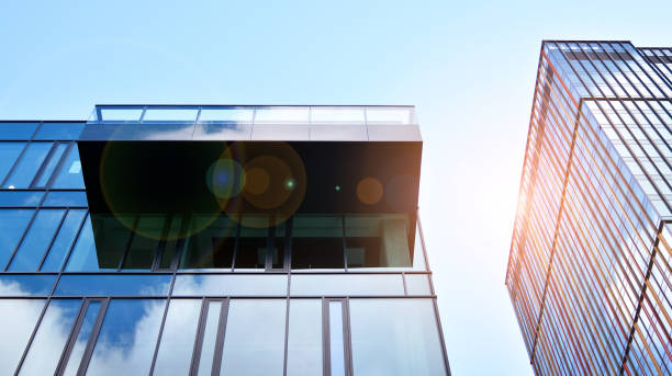 istock Modern office building with glass facade on a clear sky background. 1391879475