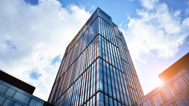 istock Modern office building with glass facade on a clear sky background. 1391879506