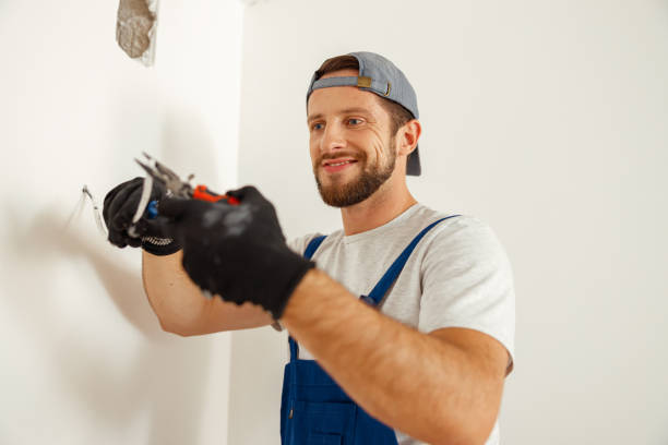 istock Hard working electrician, handyman using pliers for cutting wires, working on electric system in new apartment 1391879526
