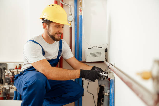 istock Cheerful male worker, plumber checking pipes while installing heating system in apartment 1391879556