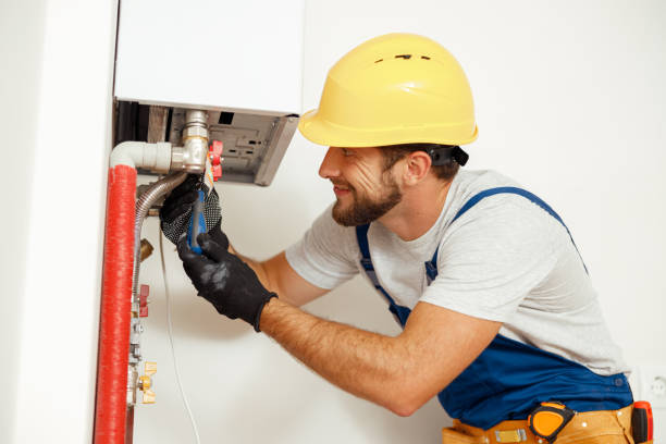 istock Side view of handyman, technician using screwdriver while fixing boiler or water heater, working on heating system in apartment 1391879582