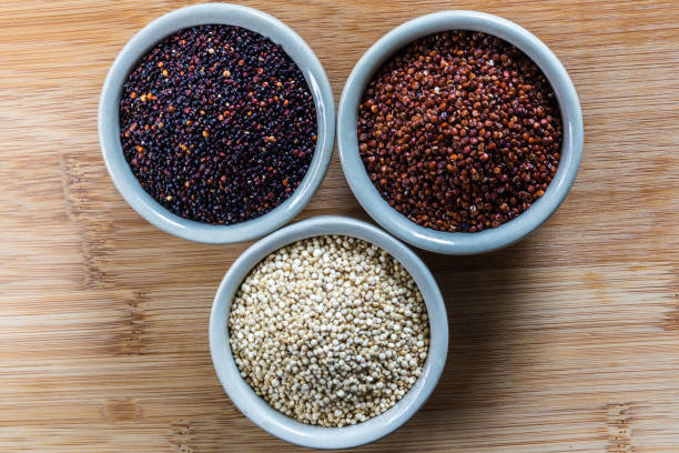 istock Red, black and white quinoa seeds on wooden background 1391880459