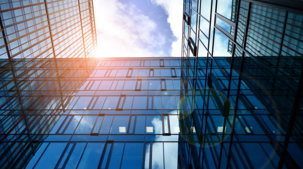 istock Modern office building with glass facade on a clear sky background. 1391880463
