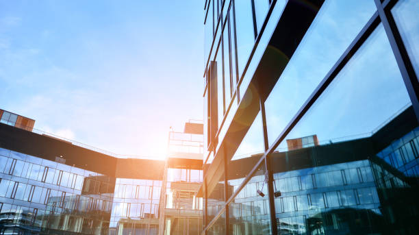 istock Modern office building with glass facade on a clear sky background. 1391881594