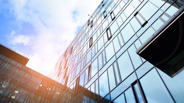 istock Modern office building with glass facade on a clear sky background. 1391881641