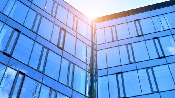 istock Modern office building with glass facade on a clear sky background. 1391881741