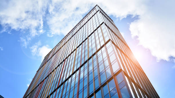istock Modern office building with glass facade on a clear sky background. 1391881886