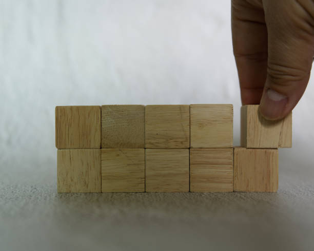 istock close-up hand choose a rectangle shape wooden dice 1391882684